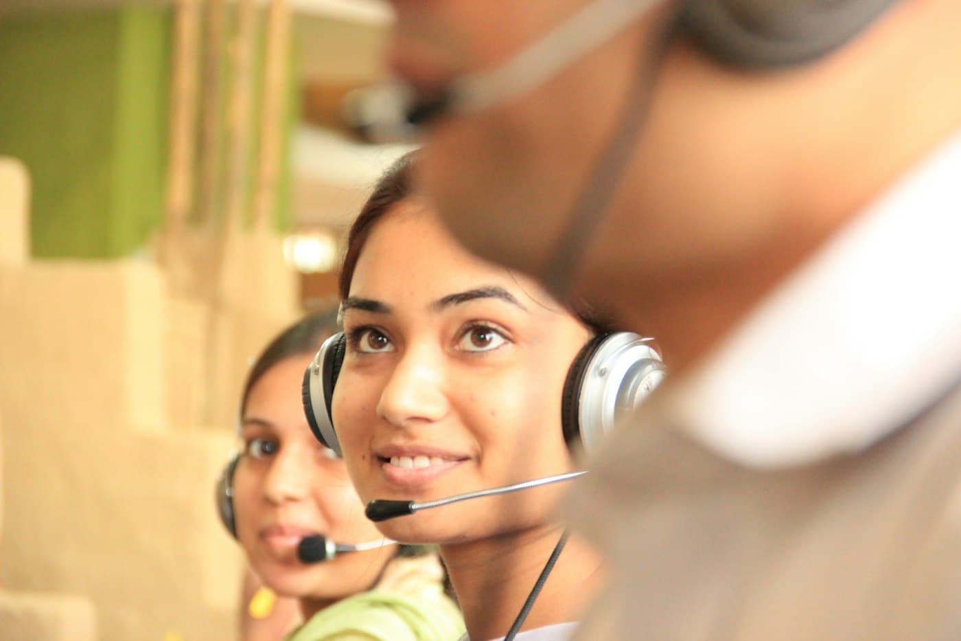 Smiling customer support adviser wearing a headset