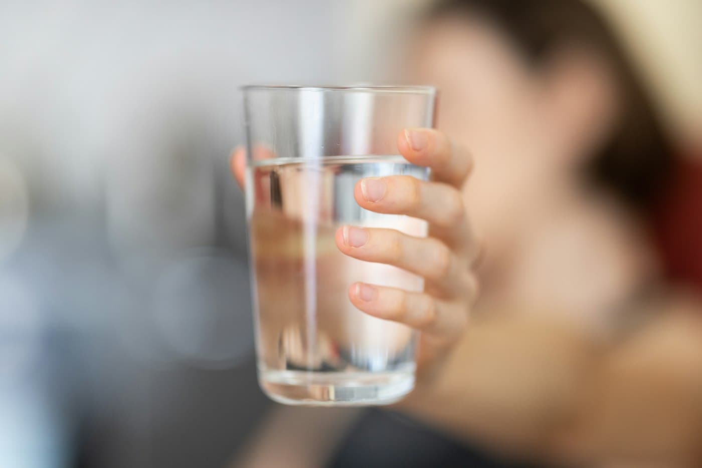 Hand holding a glass of clean water